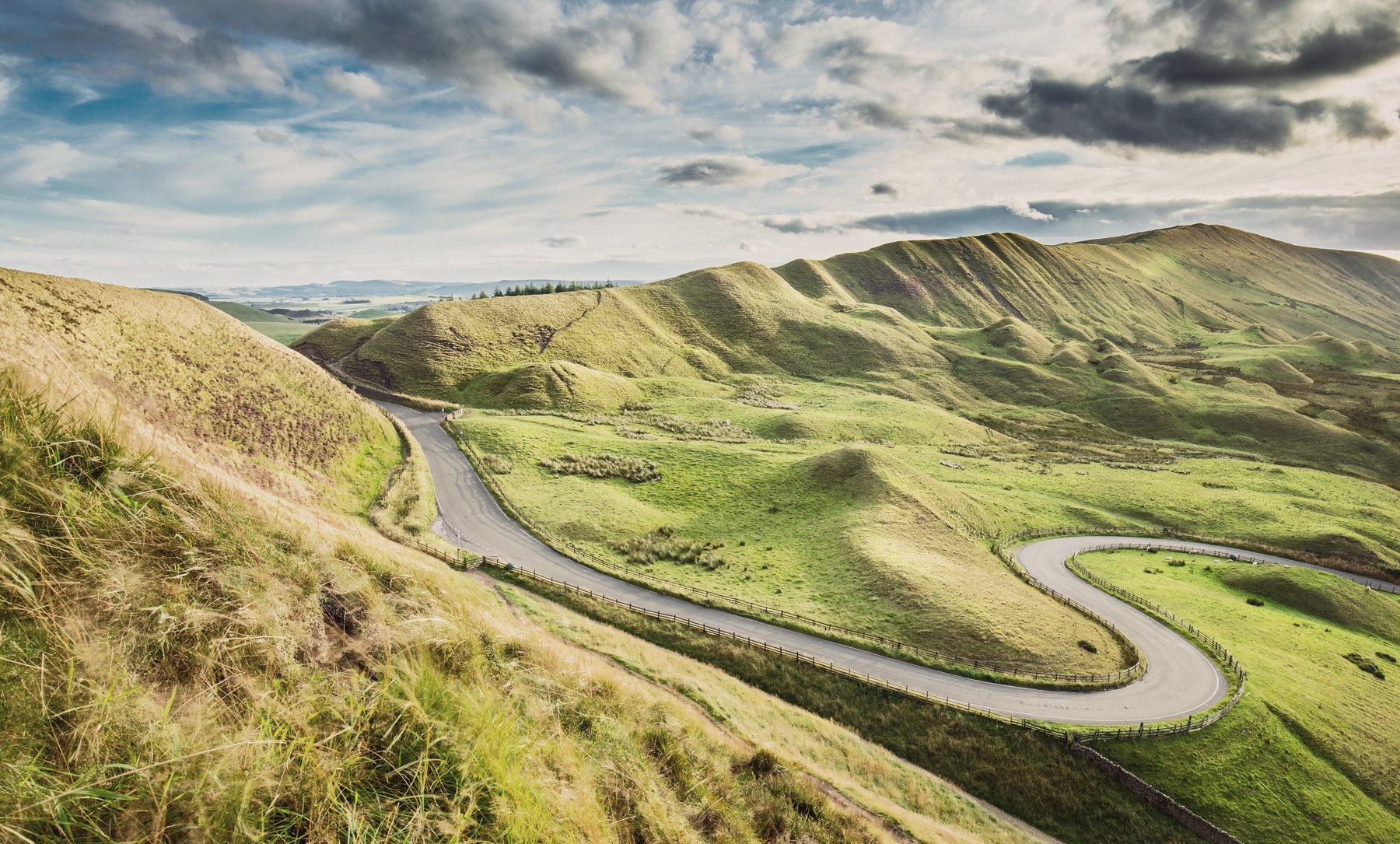 A winding countryside road through green Hampshire hills.